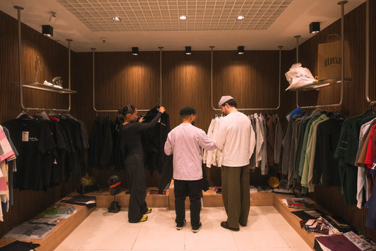 Three people looking at clothing items